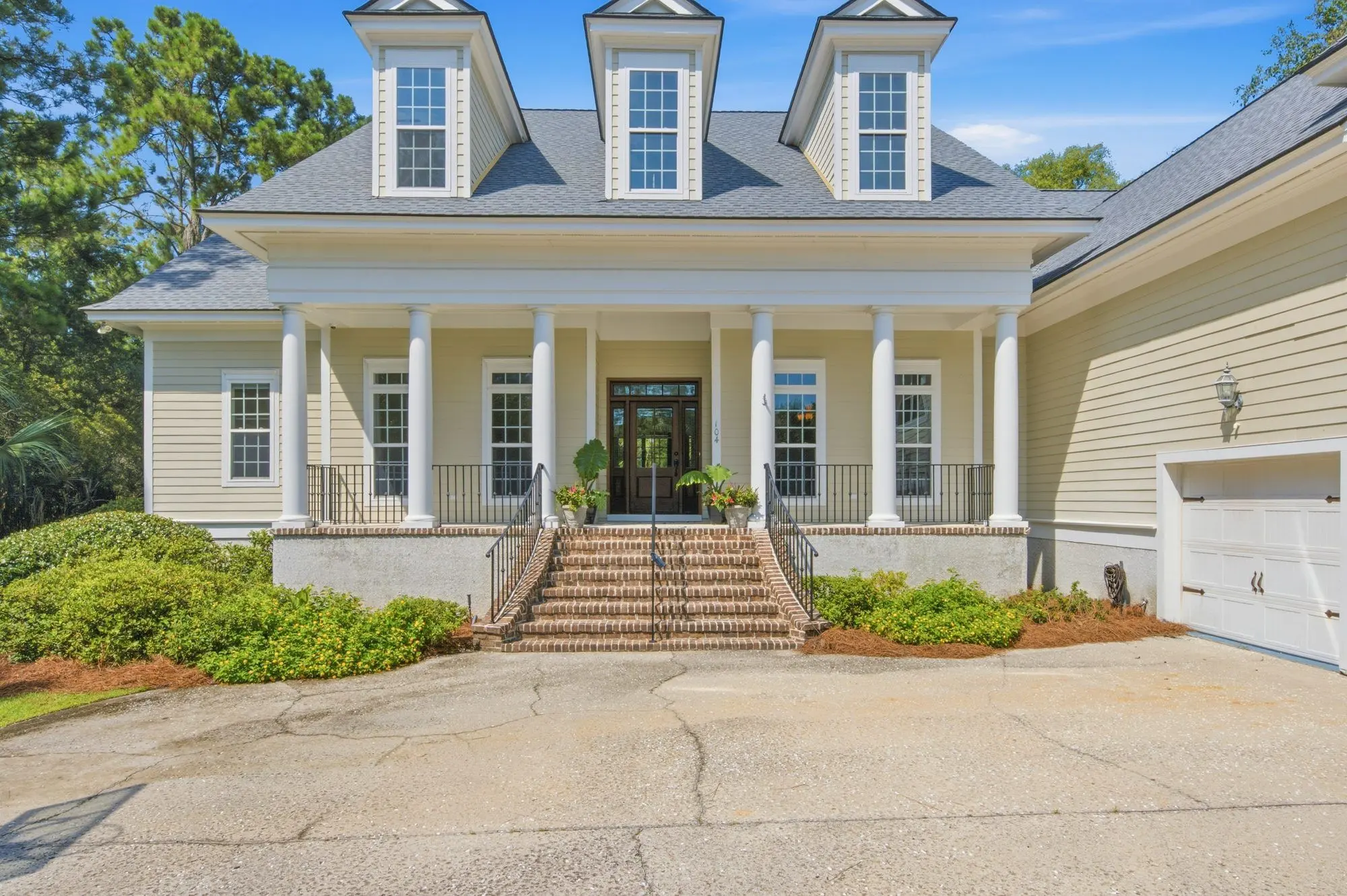 Two-story white home with double front porches in Savannah, GA